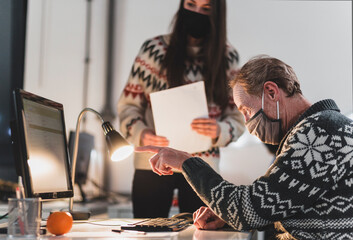 Office workers looking at computer