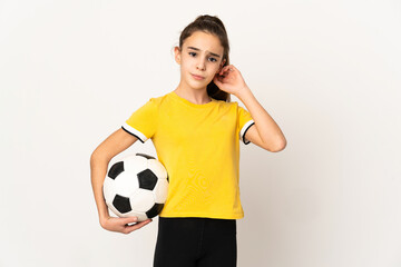 Little football player girl isolated on white background having doubts