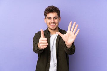 Caucasian man isolated on purple background counting six with fingers