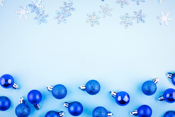 Christmas balls on a blue background from above. Merry Christmas postcard, frame. Winter holiday theme. Happy New Year.