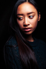 pretty young asian girl posing sensitive on black background, lifestyle people concept