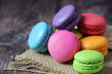 Fototapeta na wymiar Colorful macaron cake or macaroon on wooden background, Small French cakes.