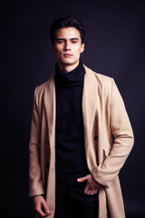 Fototapeta na wymiar handsome asian fashion looking man posing in studio on black background, lifestyle modern people concept