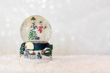 Authentic Christmas snow globe with snow falling. With copy space