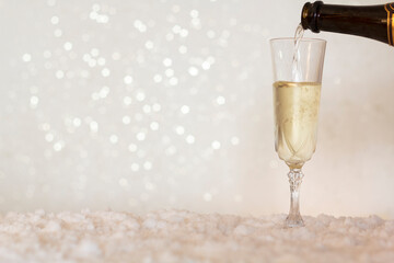 Pouring champagne from bottle into glass