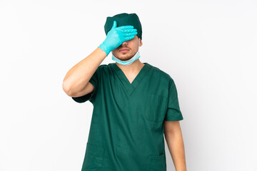 Surgeon in green uniform isolated on isolated white background covering eyes by hands. Do not want to see something