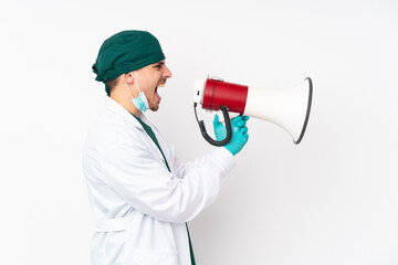 Fototapeta premium Surgeon in green uniform isolated on isolated white background shouting through a megaphone