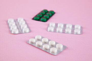 Pills are isolated on pink background.