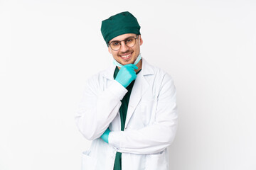 Surgeon in green uniform isolated on isolated white background with glasses and smiling