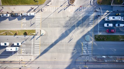 Naklejka premium Aerial view of the city traffics at the center. Vehicles are moving on the road between buildings.