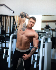 side view. young bodybuilder in the gym.