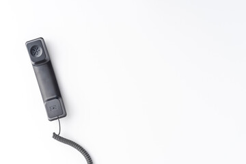 Vintage handset isolated on white desktop with copyspace. Hotline concept