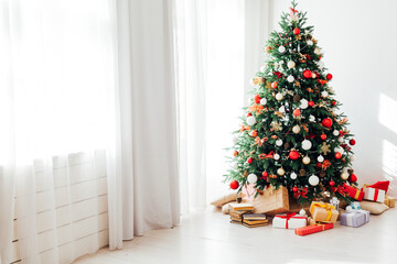Fototapeta na wymiar White room window Christmas tree with gifts decor garland interior new year