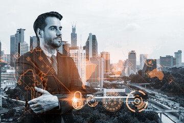 Fototapeta premium A young European cybersecurity developer in cross hand pose thinking about new concepts at security compliance division to protect clients information. IT lock icons over Kuala Lumpur background.