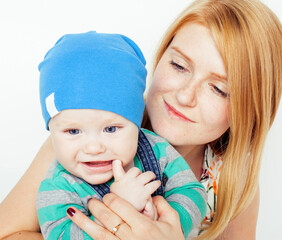 young beauty mother with cute baby toddler, red head happy modern family, lifestyle people concept