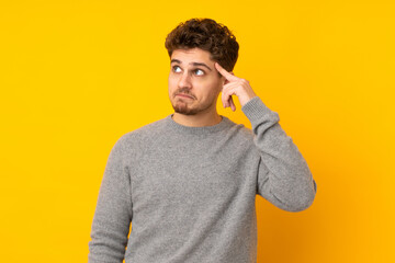 Young caucasian man isolated background making the gesture of madness putting finger on the head