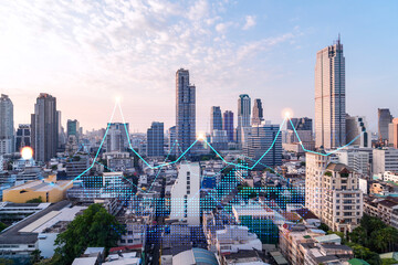 Fototapeta premium Market behavior graph hologram, sunset panoramic city view of Bangkok, popular location to achieve financial degree in Asia. The concept of financial data analysis. Double exposure.