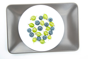 different berries on a white plate. useful vitamin healthy food fruit. healthy vegetable breakfast