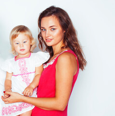 young pretty stylish mother with little cute blond daughter hugging, happy smiling real family, lifestyle people concept