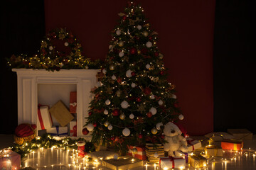 Fototapeta na wymiar Night lights garland Christmas tree with gifts decor new year