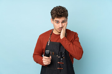 Hairdresser caucasian man isolated on blue background unhappy and frustrated