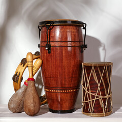 Composition of musical ethnic instrument. Maracas, tambourine, conga and ethnic drum. Percussion rhytm instruments - obrazy, fototapety, plakaty