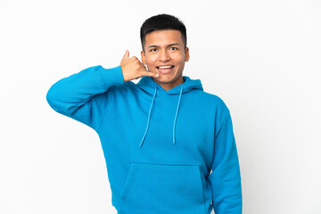 Young Ecuadorian man isolated on white background making phone gesture. Call me back sign