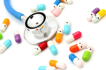 Medical capsules and pills with happy smiling faces on white background