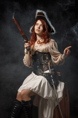 Young pirate female with long red hair. Woman is wearing a black corset bustier, tricorn hat , gun...