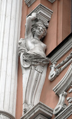 Fototapeta na wymiar Decoration of the facade of the building with sculptures and busts of Atlantes