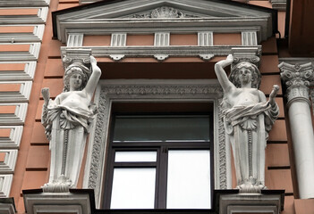 Decoration of the facade of the building with sculptures and busts of Atlantes