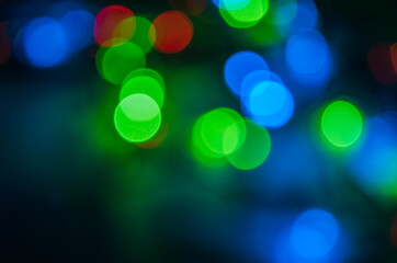 Abstract pattern of colorful bokeh lights on dark background