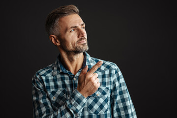 Serious grey-haired man pointing isolated