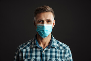 Grey-haired man wearing face mask