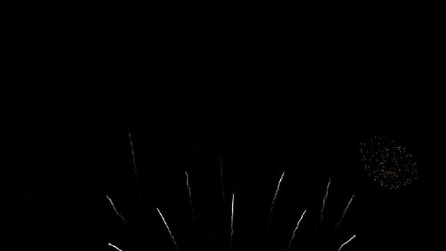 4K. loop seamless of real beautiful fireworks background during new year's eve countdown celebration, real golden shining fireworks festival in the sky at night with colorful. glowing fireworks show.