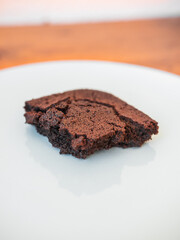 Delicious piece of brownie on a white background. Vertical shot.
