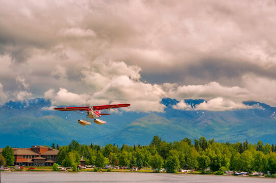 Seaplane flies over Lake Hood in Anchorage Alaska