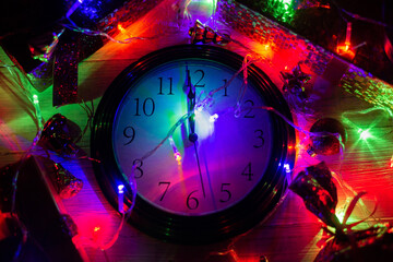 Clock showing twelve in New Year's lights. New Year's time.