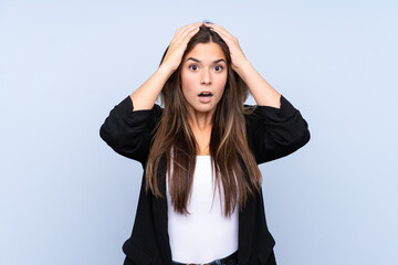 Young Brazilian business woman over isolated blue background with surprise facial expression