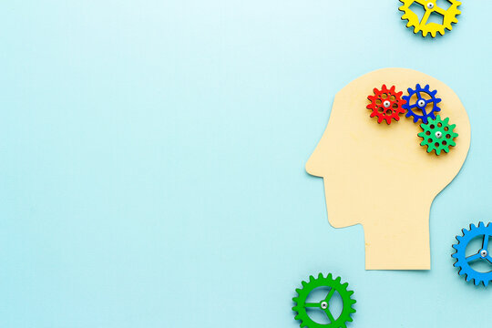 Paper head with brain of gears and cogs. Mental works concept