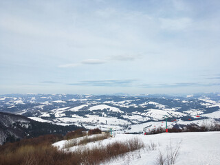 Beautiful natural landscape with mountains covered with snow. Landscape picture of ski resort from top. Active recreation in the mountains. Isolation concept during quarantine.