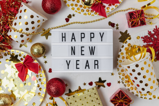 New Year 2021festive Table Decoration, Party. Christmas Gold Stars, Festive Paper Plates And Glasses, Multicolored Hearts, Gold Confetti Stars On White Background