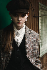 portrait of a stylish young woman with hat. Space for text. English fashion