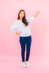 Portrait beautiful young asian woman smile with action on pink background