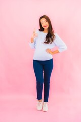 Portrait beautiful young asian woman smile with action on pink background