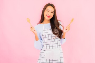 Portrait beautiful young asian woman in kitchen wear with apron
