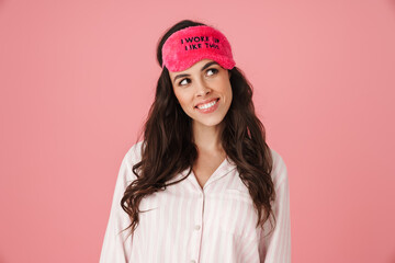 Happy beautiful woman smiling while posing in sleeping mask