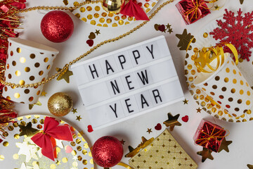 Happy new year 2021 table light box with party cup,party blower,tinsel,confetti.Fun Celebration holiday party time table flat lay invitation or greeting card. New year eve concept on white