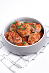 Meat cutlets with mixed mince in the ceramic bowl on the white table. Hot homemade meal