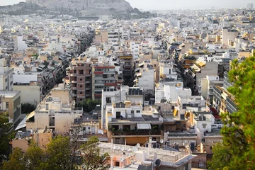 Fotobehang Partial view of Athens city with Acropolis hill in the background - Athens, Greece, June 13 2019. © Theastock